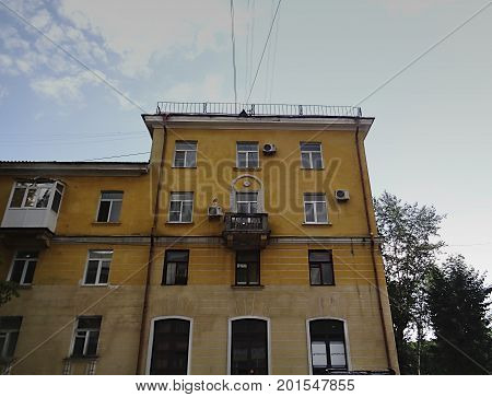 Kazakhstan, Ust-Kamenogorsk - 01, August 2017. Residential building on Independence Avenue. Architecture. Architectural background. Antique architecture. Yellow house.