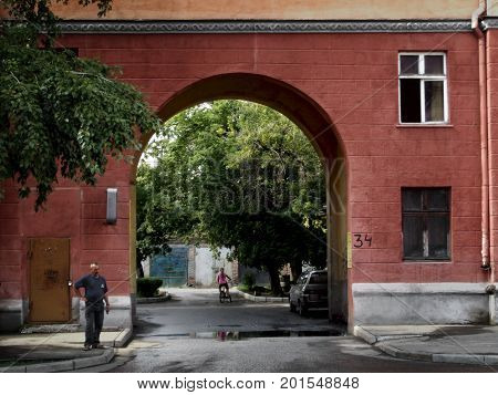 Kazakhstan, Ust-Kamenogorsk - 01, August 2017. Fragment of a building with an arch on Gogol street. Architecture. Architectural background. Antique architecture.