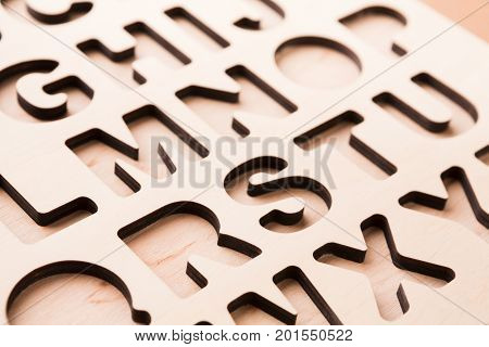 English alphabet stencil closeup, empty sorter for kids development