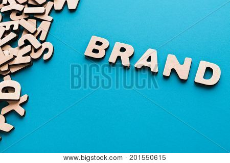 Word Brand on blue background. Famous name, trendy goods, tendency concept