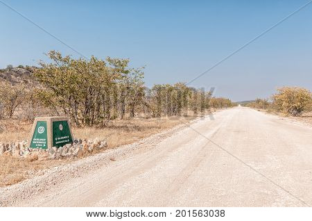 ETOSHA NATIONAL PARK NAMIBIA - JUNE 27 2017: A distance marker at the Rateldraf turn-off in the Western part of the Etosha National Park in Namibia