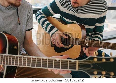 Learning to play the guitar. Music education and extracurricular lessons. Guitarist