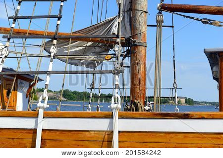 Nautical maritime scene with ropes and mast on a ship on a dock by the water