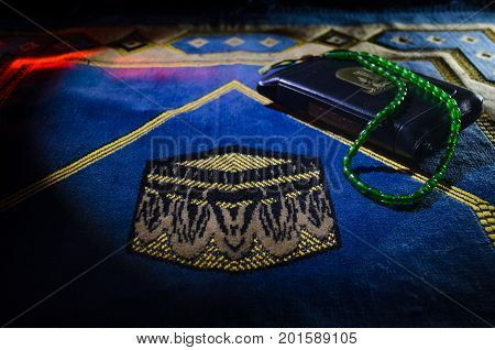 Holy Quran With Beads On A Prayer Mat, Muslim Tasbih Is A String Of Prayer Beads Which Is Traditiona
