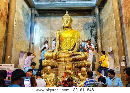 Samut Sakhon, Thailand - August 12, 2016: Buddha statue church old brick wall and tree root in Wat Bang Kung Samut Sakhon Thailand.