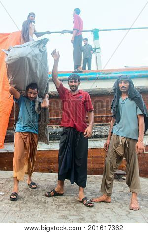 Hard Working Dockers In Traditional Dhow Wharfage Port