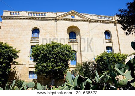 VITTORIOSA, MALTA - MARCH 31, 2017 - View of the side of the Malta maritime museum with prickly pear cactus in the foreground Vittoriosa Malta Europe, March 31, 2017.
