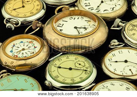Vintage pocket watch on a black background.
