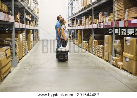 Young pregnant couple in diy store. Repair building renovation and home concept