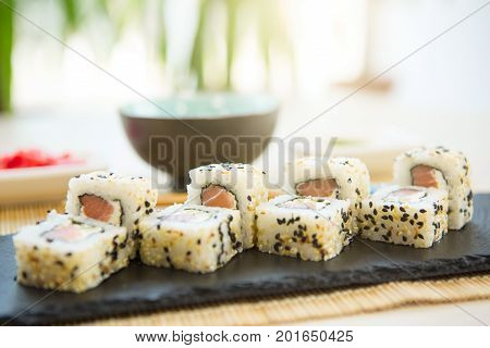 Fresh Homemade Sushi Roll. Fried Sushi On Black Slate Surface. Japanese Food