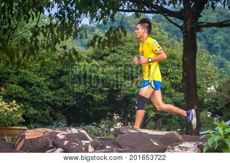 Kota Kinabalu,Sabah,Malaysia-Aug 8,2017:Healthy active man jogging in a park in the evening at Likas,Kota KInabalu,Sabah,Malaysia.