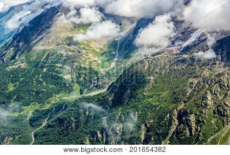 Amazing nature view of green mountain forest and tree growing on a rock, natural landscape perspective, Caucasus, Russia.