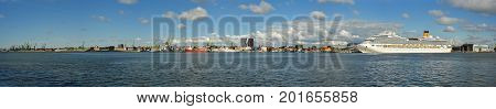 Klaipeda, Lithuania - August 20, 2017: Beautiful view on Klaipeda and Curonian Lagoon from The Curonian Spit, Lithuania. Beautiful summer panorama on Klaipeda, Curonian Lagoon and big cruise ship.