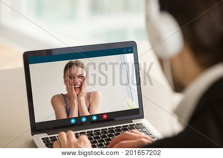 Man video calling woman, talking by web cam with smiling teen girl on laptop screen, using app for virtual chat on computer, friendly online conversation between young couple, e-dating, close up