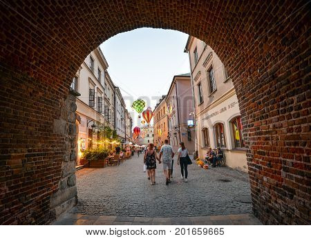 Lublin, Poland - August 10, 2017: Beautiful street and old buildings in the old town of Lublin, Poland. Center of Lublin, Brama street. View through Cracow gate on old Lublin street.