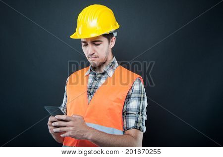 Constructor Wearing Equipment Texting On Smartphone