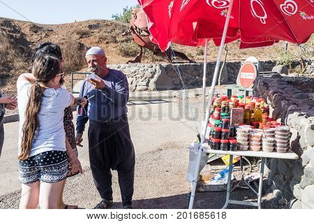 Golan Heights Israel August 27 2017 : The seller - druz trades with buyers up his store with canned sweets in the parking lot on Mount Bental. on the Golan Heights in Israel.