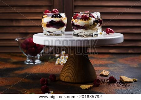 Homemade dessert in glass jars. Cheesecake, trifle, mouse on grunge stone background. Copy space