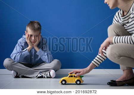 Kid Looks On Yellow Toy