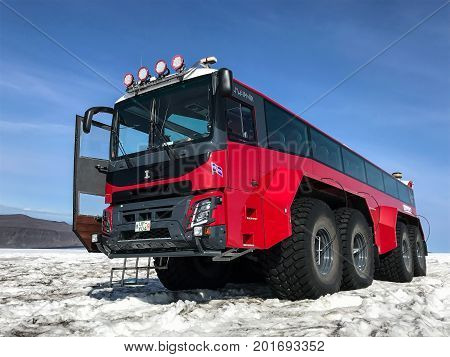 Husafell Iceland August 22 2017: Red specialty vehicle for driving on the snow stands on the surface of Langjokull glacier. This is a part of 