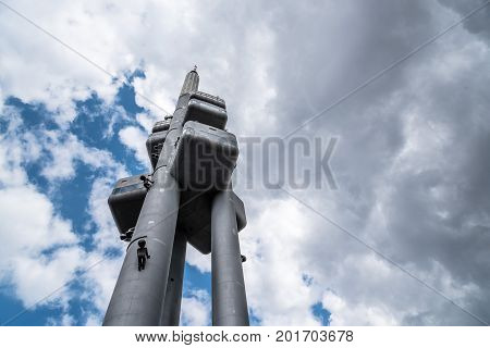 Prague, Czech Republic - August 21, 2017: Zizkov Television Tower in Prague. It is is a  transmitter tower and an example of high tech architecture. Low angle view a cloudy day of summer.