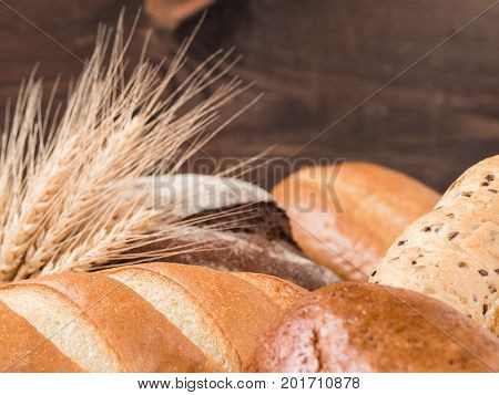 Close up view of differnet bread on brown wooden background. Copy space. Shallow DOF.