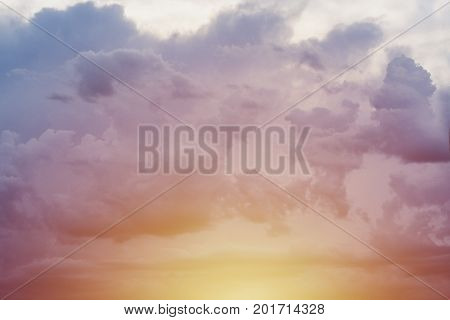Sunset yellow blue sky with dark clouds background