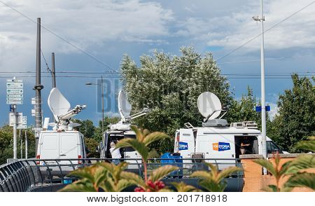 STRASBOURG FRANCE - JUN 30 2017: Viastoria Media Television Trucks with multiple Satellite parabolic antennas and fiber optic cables preparing to report live the official European Ceremony of Honour for Dr. Helmut Kohl at European Parliament