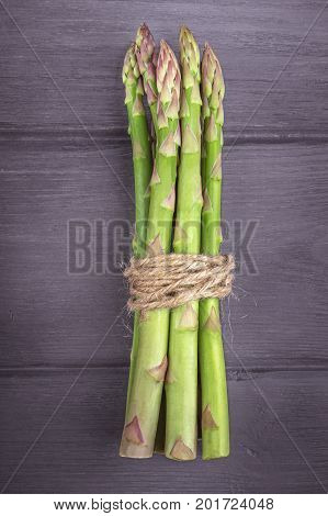Bunch of fresh asparagus on wooden rustic background.