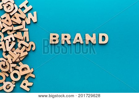 Word Brand on blue background. Famous name, trendy goods, tendency concept