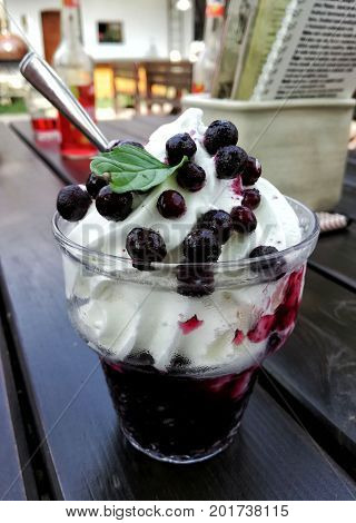 Natural ice cream with blueberries. Hot day in the countryside.