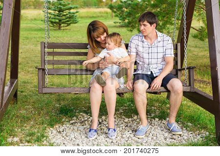 young happy family are walking and playing outdoors in warm autumn.