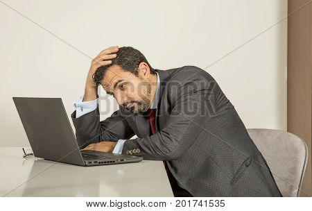 Arab Man Woking In His Laptop In The Kitchen