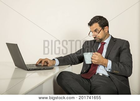 Arab Man Woking In His Laptop In The Kitchen