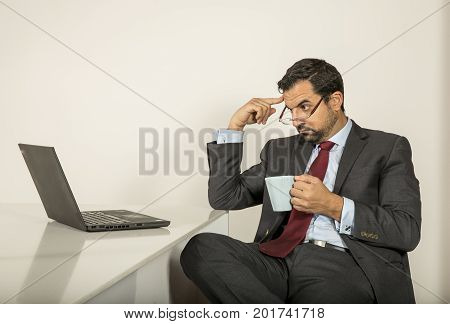 Arab Man Woking In His Laptop In The Kitchen