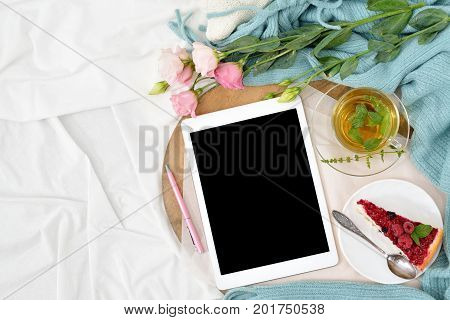 Flat Lay Breakfast In Bed With Raspberry Cheesecake, Mint Tea And Open Note Book, Tablet