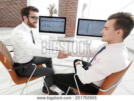 handshake financial partners sitting at Desk
