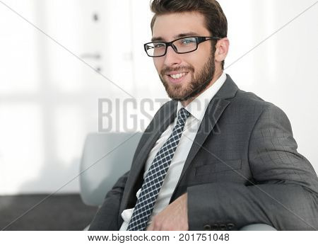 closeup.confident businessman sitting in a chair
