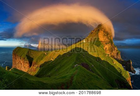 Kalsoy island and Kallur lighthouse in sunset light Faroe Islands
