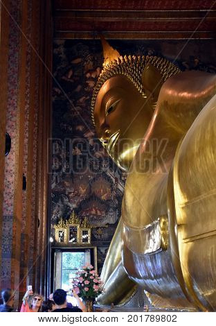 Bangkok Thailand - Aug 4 2017. Big golden Reclining Buddha in Wat Pho temple is the landmark of Bangkok Thailand and Asia. One of the oldest largest and most revered temple complexes in Bangkok.