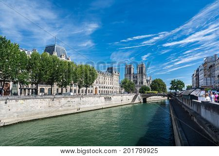 Paris France - August 13 2016: The Cathedral Notre-dame de Paris and the river Seine. Notre-Dame is a medieval Catholic cathedral on the ile de la Cite in the fourth arrondissement of Paris France.