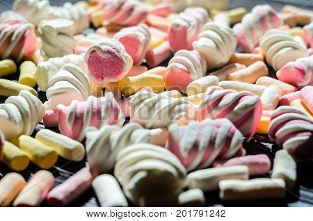 Multicolored Marshmallow Background. Background of multi-colored and different in shape and size of marshmallows. Sweets background