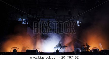 Music band silhouette on stage, night entertainment, music festival