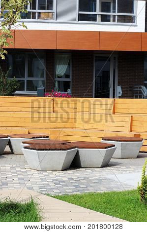 Park Bench In A Spring Garden. New Modern Courtyard.