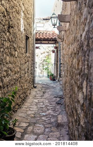 Old narrow street in Stari Grad of Ulcinj Montenegro. The fortress in the Old town in a sunny summer day.