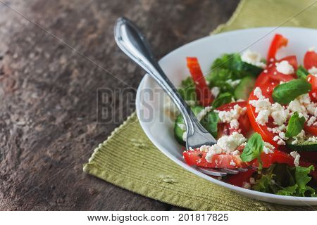 Shopska Salad In A White Plate On A Wooden Background, Close-up