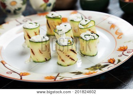 Grilled zucchini rolls filled with fresh cottage cheese
