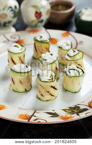 Grilled zucchini rolls filled with fresh cottage cheese