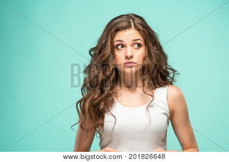 The portrait of alarmed young woman with shocked facial expression