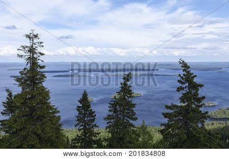 View of lake Pielinen, from Ukko-Koli hill in Karelia, Finland. Trees this side, sunshine.